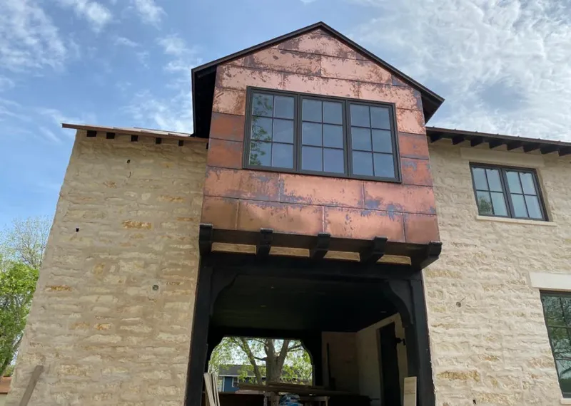Copper metal panel facade on a stone building for Skylight Installation in McDonough