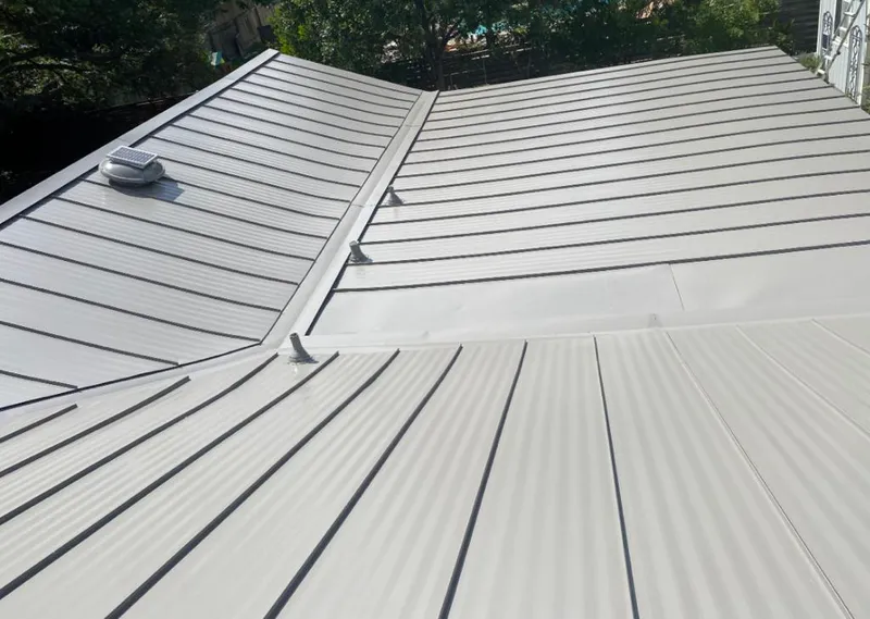 Solar attic fan installed on a metal roof for Roof Ventilation in McDonough